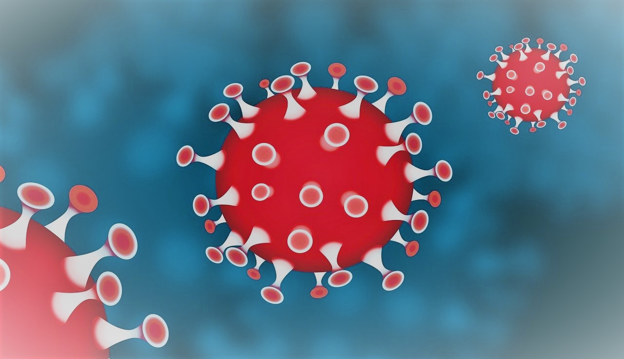 Piirretty kuva kolmesta punaisesta koronaviruksesta. Sininen tausta.