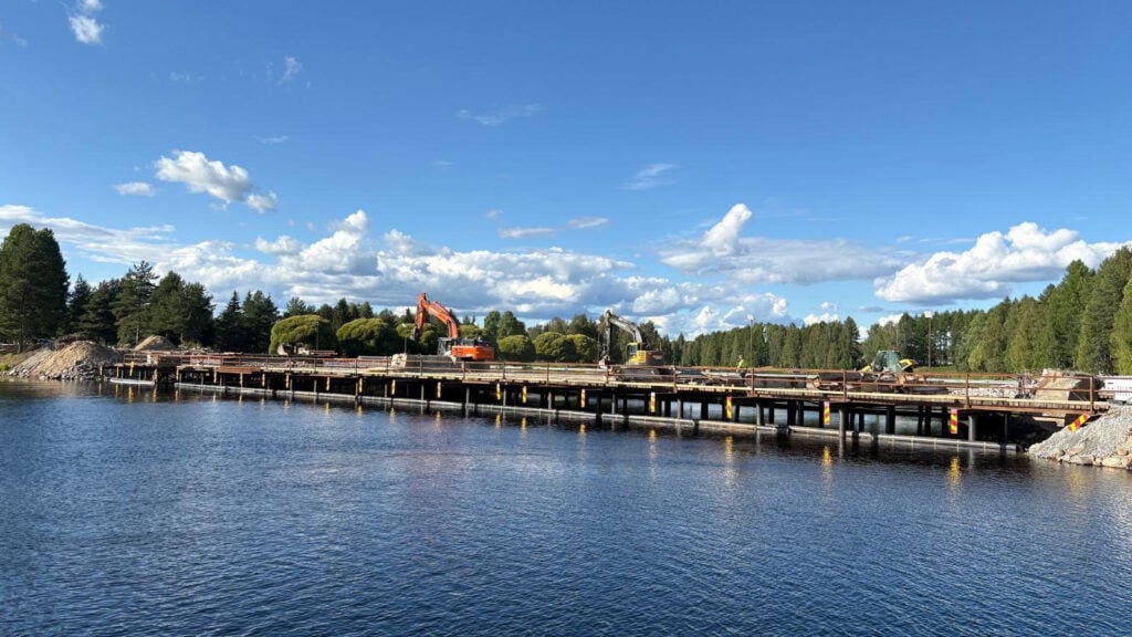 Siltatyömaa. Vanha kaarisilta on purettu, siltatyömaalla näkyy työkoneita. 